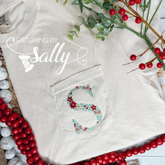 An ivory shirt featuring exquisite floral embroidery customized with the letter "S" on the pocket, surrounded by red berries and green leaves.