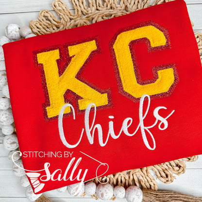 A red crewneck sweatshirt featuring a yellow chenille "KC" and white "Chiefs" embroidery, showcasing team spirit and style.