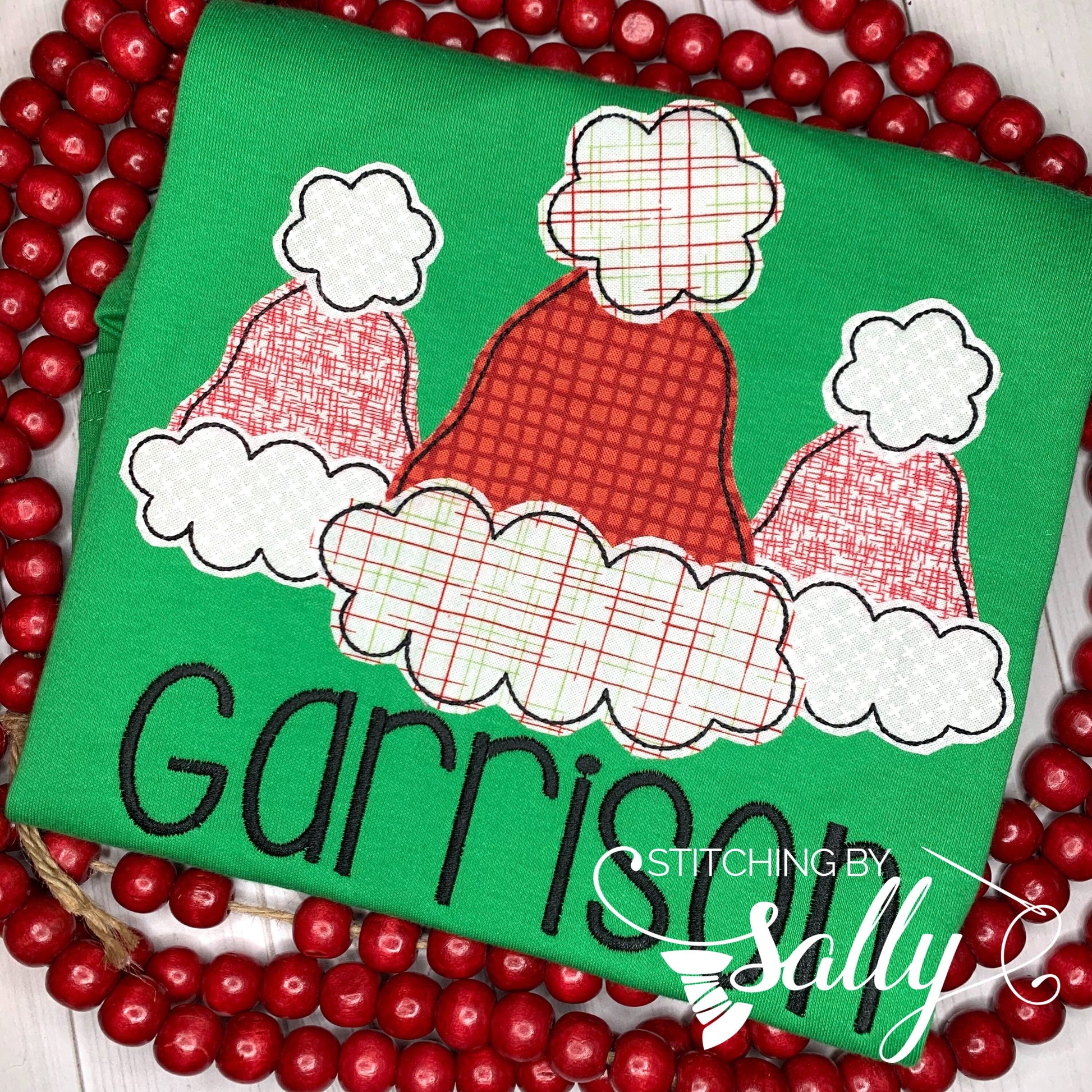 Boys green shirt applique with santa hats in red and white fabric